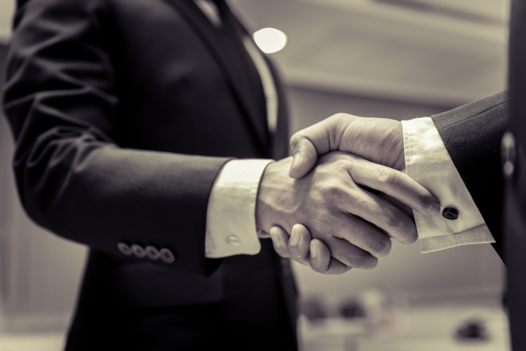 business-people-shaking-hands-finishing-up-a-meetingnegotiations-were-successfully