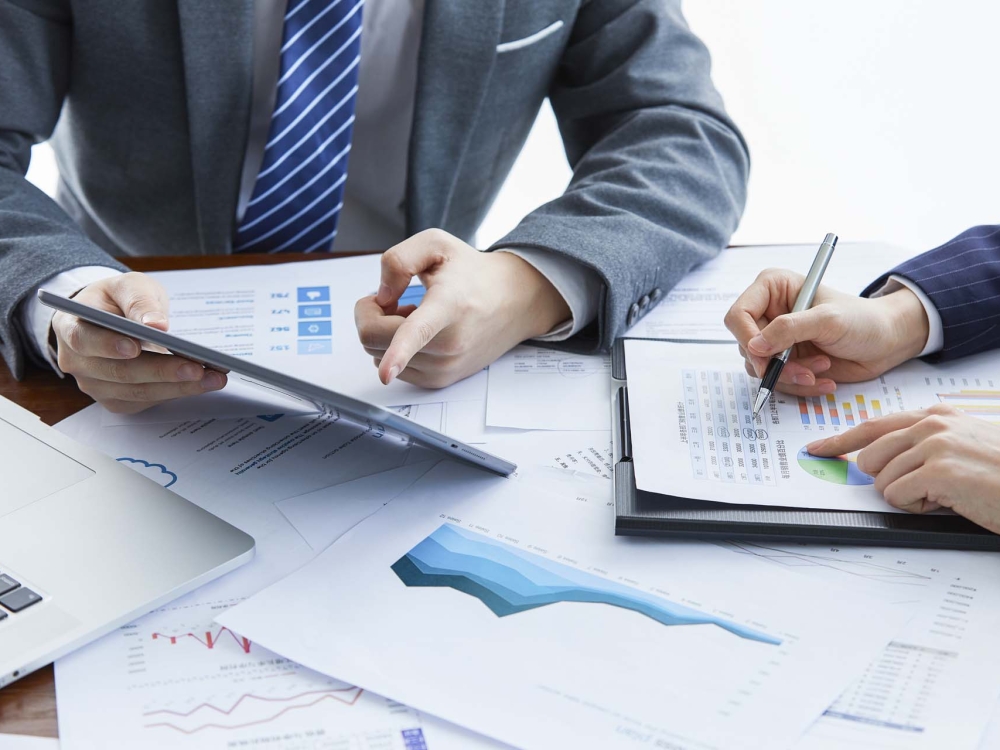 Two businessmen in elegant suits at a business meeting discussing a new project in the office